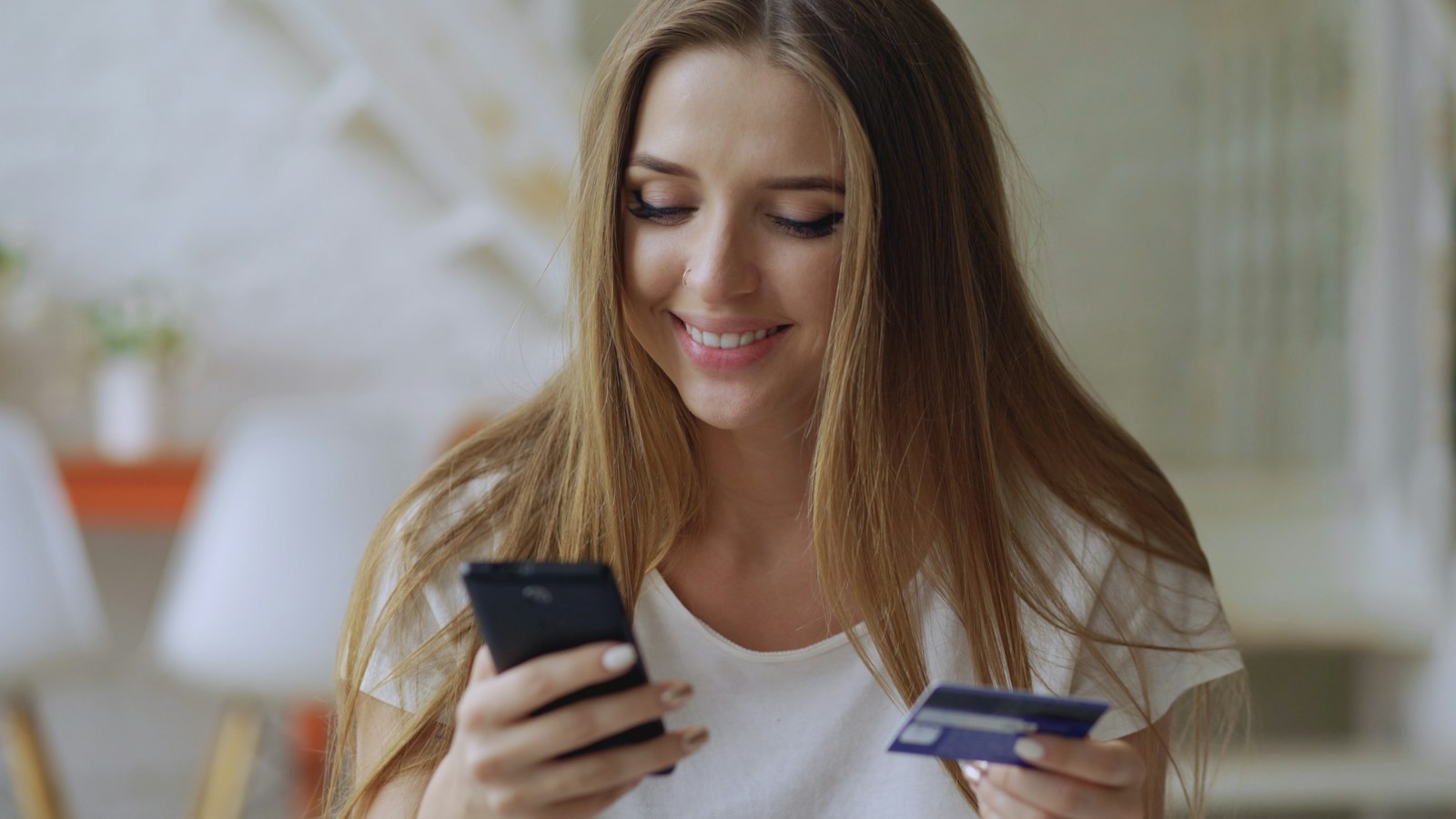 Buyer purchasing an event ticket online with a phone and card